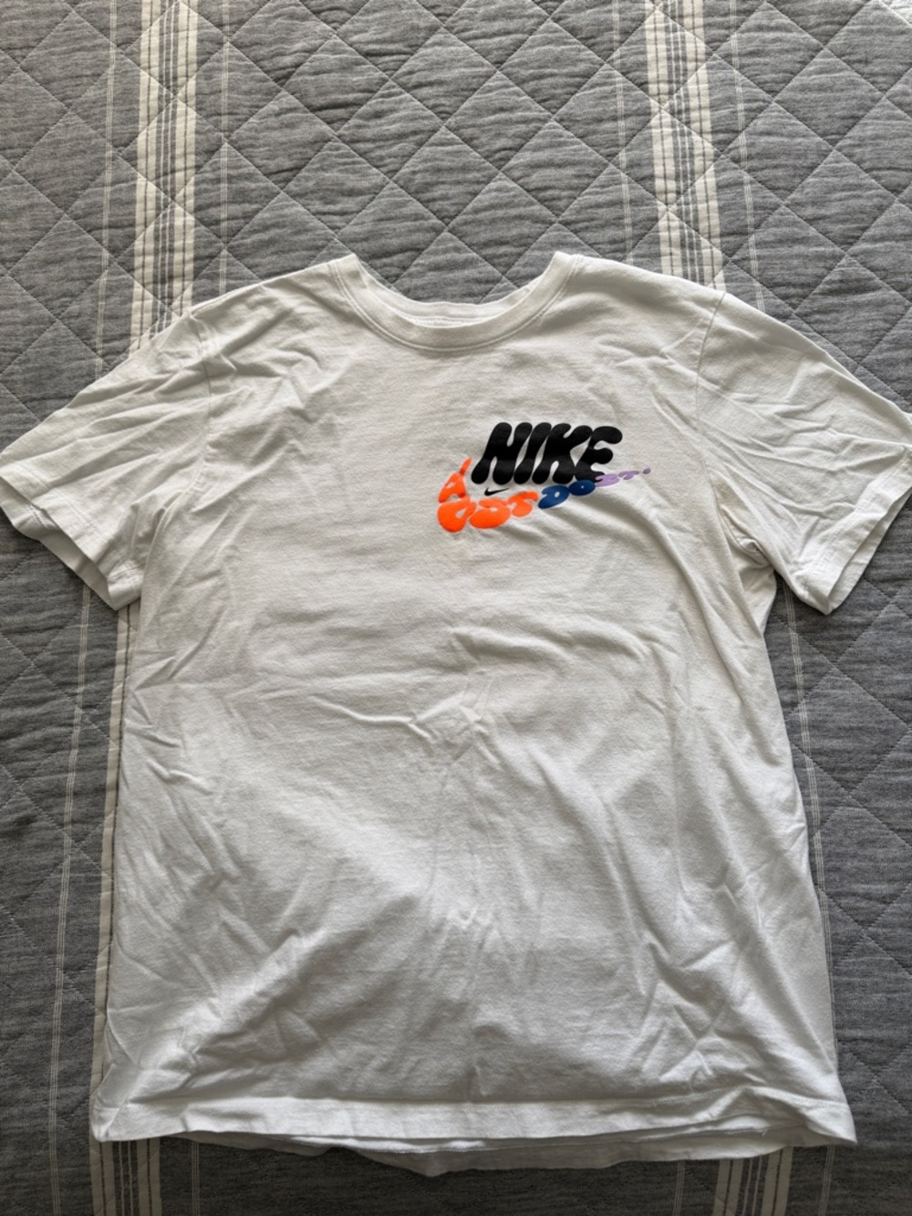 Nike White Short Sleeve T‑Shirt with Black, Orange and Blue Logo